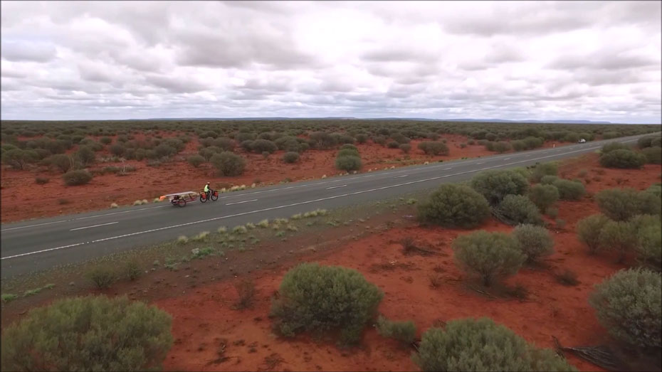 Sam Mitchell rides his homemade bike through the desert.