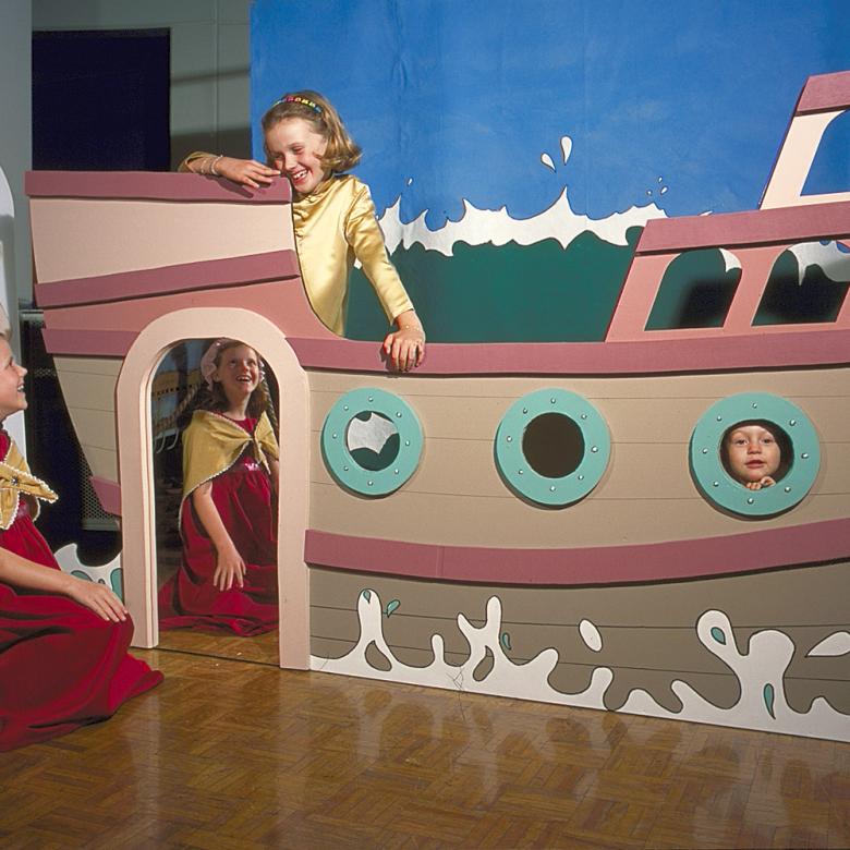 Children play with a model boat