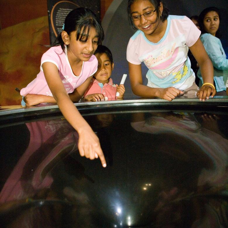 Children point into a model black hole