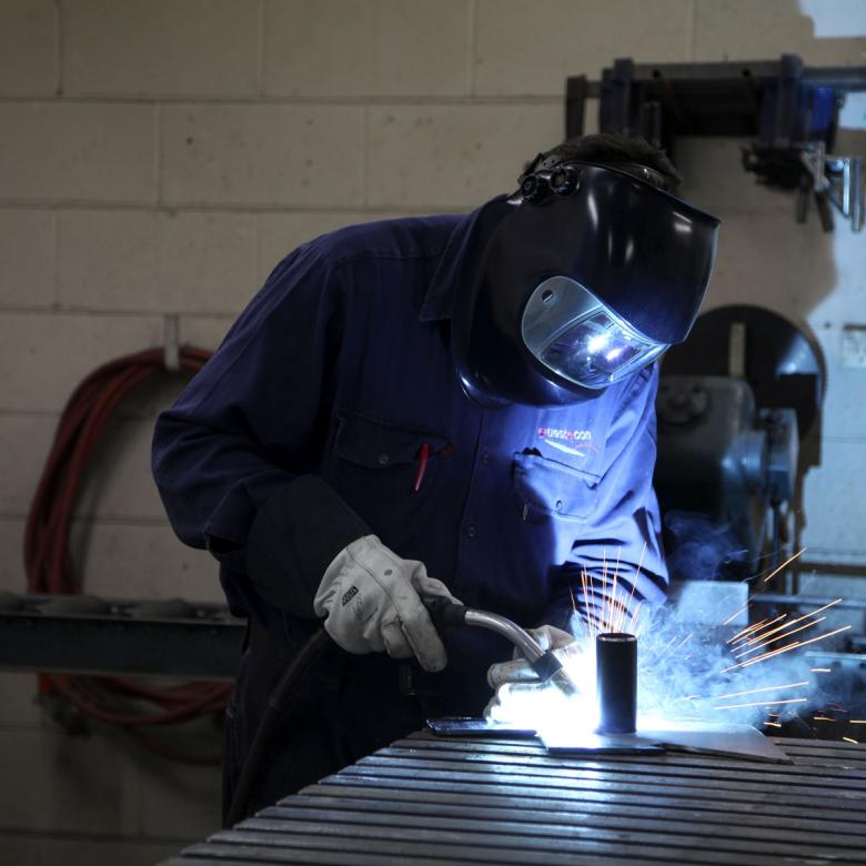 A Questacon staff member welds