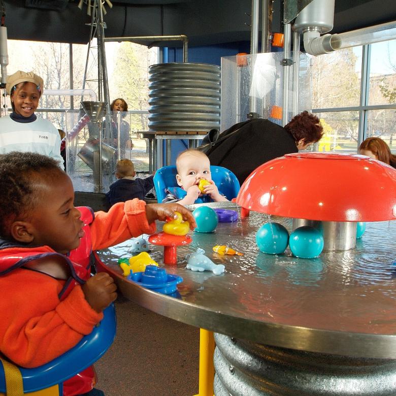 Young children play with water