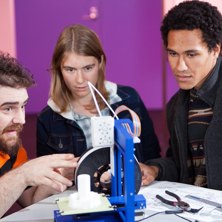 People watch a 3D printer