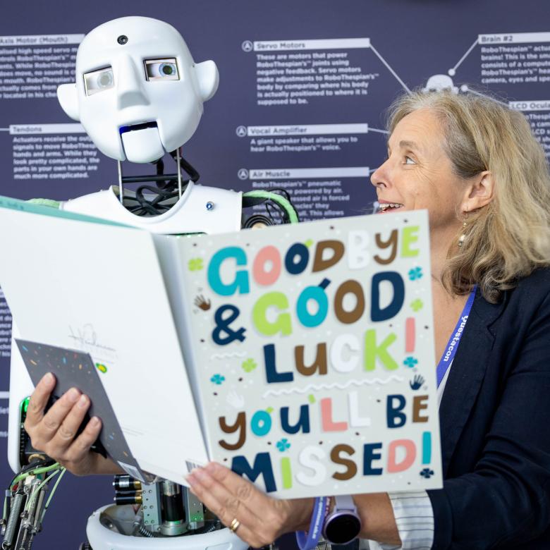 RoboQ and Questacon Director, Jo White, reading a farewell card. 