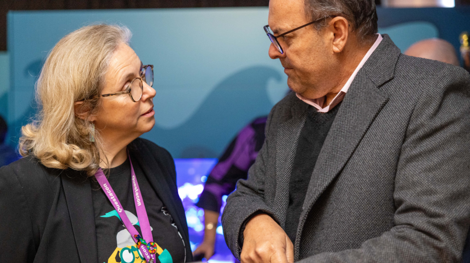 Dr. Harry Van Issum and Jo White look at a phone