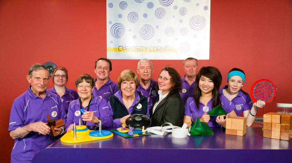 Image of Questacon Volunteers around an exhibit